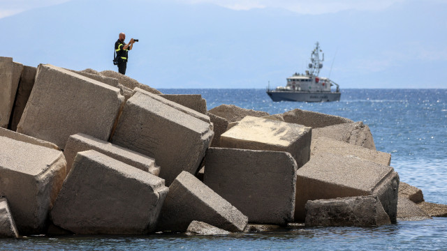 A member of Italy`s fire and rescue service watches as the rescue operation for the missing yacht passengers continues, in Porticello, Sicily Island, Italy, 21 August 2024.